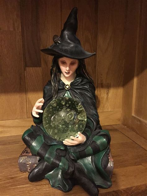 Witch figurine with glowing lights and captivating sounds